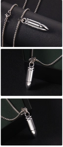 Macro shot of silver bullet-shaped stainless steel pendant and sleek metal necklace