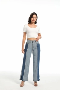 Detail of color-block contrast stitching and frayed hem on women's slim fit jeans