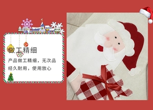 Detail of Christmas stocking featuring Santa Claus applique and plaid bow decoration
