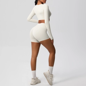 Rear view of cream yoga set showing tight fit crop top and high waist shorts
