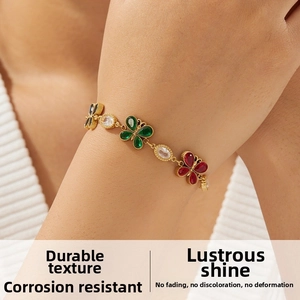 Close-up of gold-plated butterfly chain bracelet with multicolored rhinestone accents