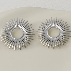 Top-down view of silver 304 stainless steel radial spike earrings with hollow center