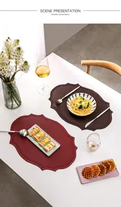 Detailed view of scalloped edge faux leather placemats in deep red and brown colors