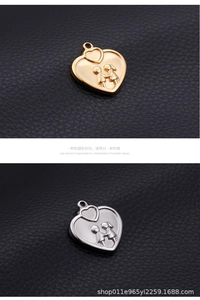 Macro detail of gold and silver heart-shaped pendants with couple relief on black leather