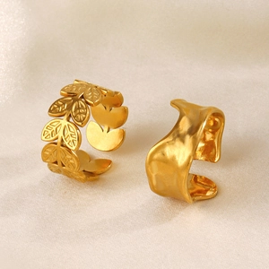 Adjustable golden stainless steel olive leaf and wavy organic rings on white silk