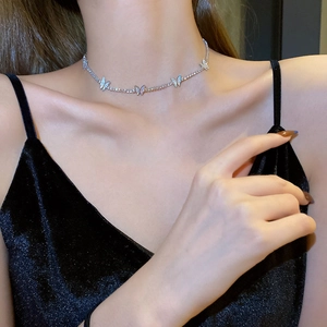 Close-up of sparkling silver butterfly choker necklace with inlaid crystals on a model
