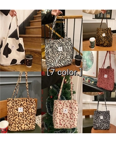Detail view of large corduroy tote bags in animal prints and floral patterns on stairs