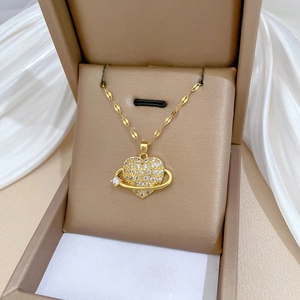 Luxurious gold heart necklace with sparkly crystals on a premium satin background