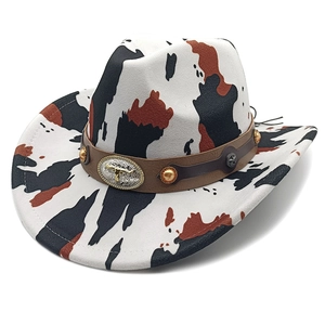 Close-up of cow print cowboy hat with brown leather band and silver bull head ornament
