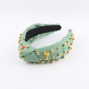 Fashionable green and white striped knotted headband with pearls and heart charms