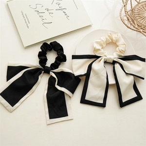 Detail of silk bow scrunchies with long streamers in black and white contrast design