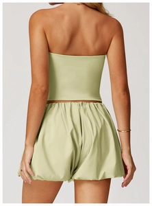 Back view of a woman wearing a light green two-piece quick-dry yoga set with shorts