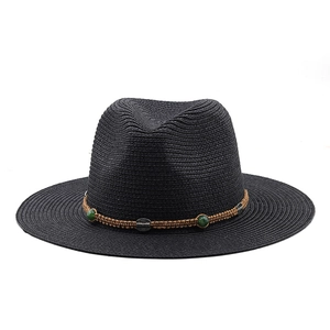Detail of woven black straw fedora with ethnic beaded band and vintage silver accents