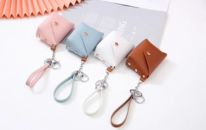 Detailed view of mini PU leather coin purses in pink, blue, white, and brown colors