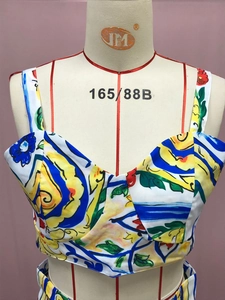 Detailed close-up of blue and yellow floral print crop top with V-neckline pleats