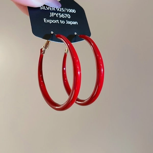Detail of high-gloss red enamel 925 silver large hoop earrings with hallmark tag