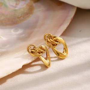 Minimalist chain link earrings in 18K gold plated stainless steel on a shell