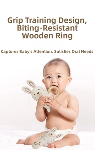 Close-up of baby grasping a soft organic cotton bunny toy with natural wooden teether ring