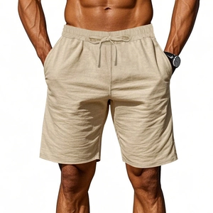 Detail of light khaki linen shorts featuring a drawstring waist and breathable fabric texture
