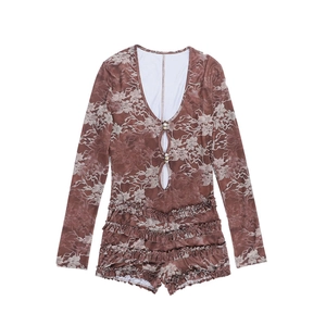 Close-up of deep V-neck and floral lace detail on a long sleeve slim fit romper
