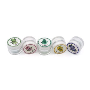 Detail view of five 5g lash extension glue removers in aloe, lily, matcha, lemon, and blueberry