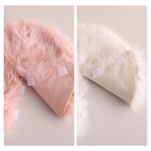 Pink and white faux fur Christmas tree skirt with plush texture and velcro fastening