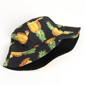 Detailed pattern of yellow pineapple print on black cotton canvas sun bucket hat