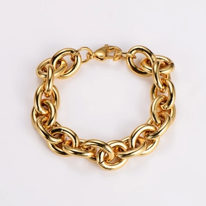 Close-up of a chunky gold stainless steel interlocking link bracelet with lobster clasp