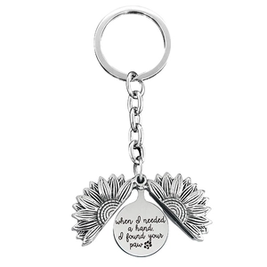 Detail of sunflower keychain engraved with when I needed a hand I found your paw phrase
