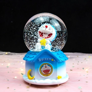 Doraemon musical snow globe with astronaut theme and blue resin base decoration
