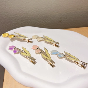Colorful tulip floral metal hair clips with enamel finish on a white jewelry tray