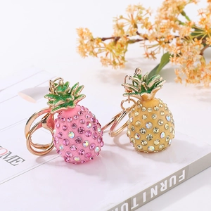Detail of rhinestone pineapple keychain with golden lobster clasp and sparkling crystals