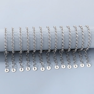 Silver stainless steel letter charms N to Z hanging on display rack for bracelets