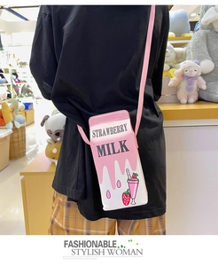 Detail shot of creative strawberry milk carton crossbody bag showing real-life wearing effect