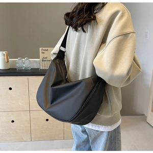 Close-up of the large black nylon dumpling bag showing its drape and spacious capacity