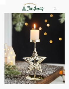 Detail of a gold star-shaped Christmas candle holder with hollow metal craftsmanship