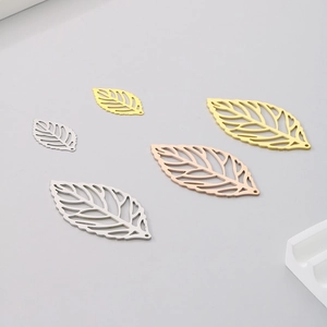 Detail of hollow leaf pendants in gold, silver and rose gold for DIY jewelry making