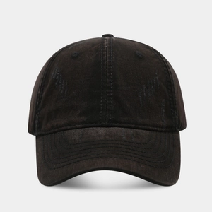 Detailed view of washed cotton fabric with distressed vintage holes on a baseball cap