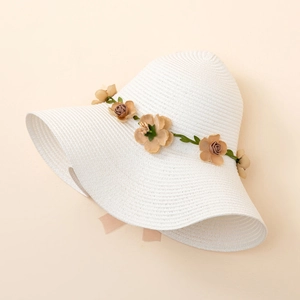 Detailed close-up of large brim straw hat with 3D floral accents for sun protection
