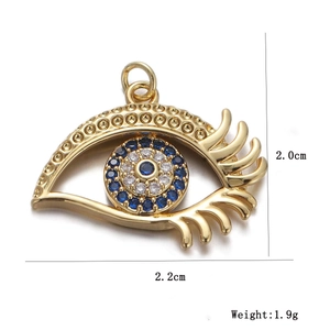 Macro detail of gold evil eye pendant with blue zircon stones and size dimensions
