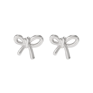 Detail shot of silver ribbon bow earrings with a polished metallic finish on white background