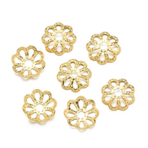 Detailed close-up of golden flower-shaped spacer beads for DIY jewelry making