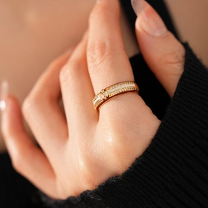Detailed close-up of an 18k gold plated butterfly ring with white enamel and zircons