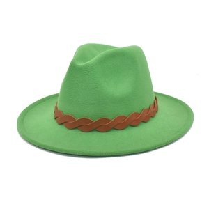 Detail of bright green fedora hat featuring a brown braided leather band and flat brim