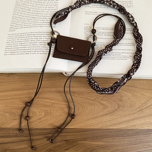 Detail of vintage brown mini neck pouch with paisley scarf strap and wooden bead accents