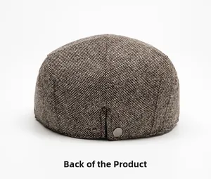 Rear view of brown tweed flat cap with adjustable metal snap button and warm texture