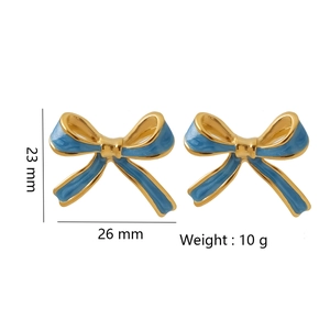 Detail view of light blue enamel bow earrings with dimensions and 10g weight scale