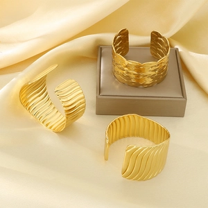 Wide gold stainless steel cuff bracelets with textured wave and hammered stripe designs