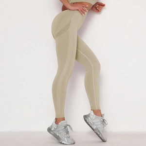 Detail of khaki seamless high-waisted yoga leggings with ribbed texture and lifting effect