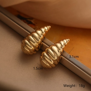 Detailed view of spiral teardrop earrings in gold plating with weight and size labels
